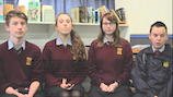 Four students seated looking at the camera.
