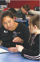 two students sitting at a desk.