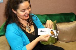 Teacher holding a flashcard.