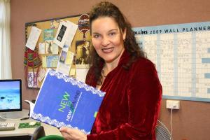 Teacher holding a book.